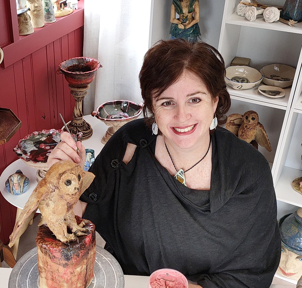 Image of Lee-Anne Peters at her work table with a ceramic sculpture for her Grand Opening Events News story with Art Trails Tasmania