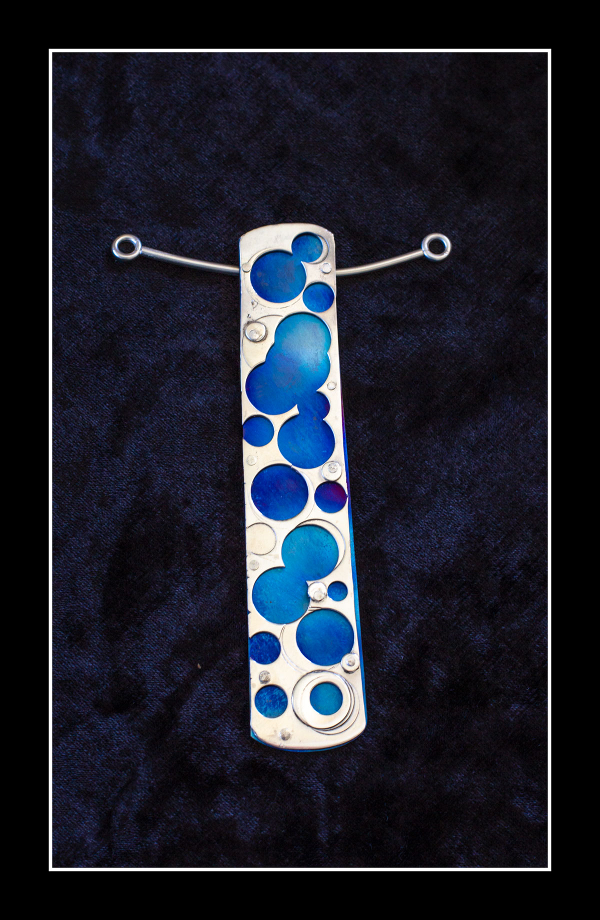Image shows silver and blue enamel circles pendant by Russell McKane for his Artist Profile with Art Trails Tasmania story