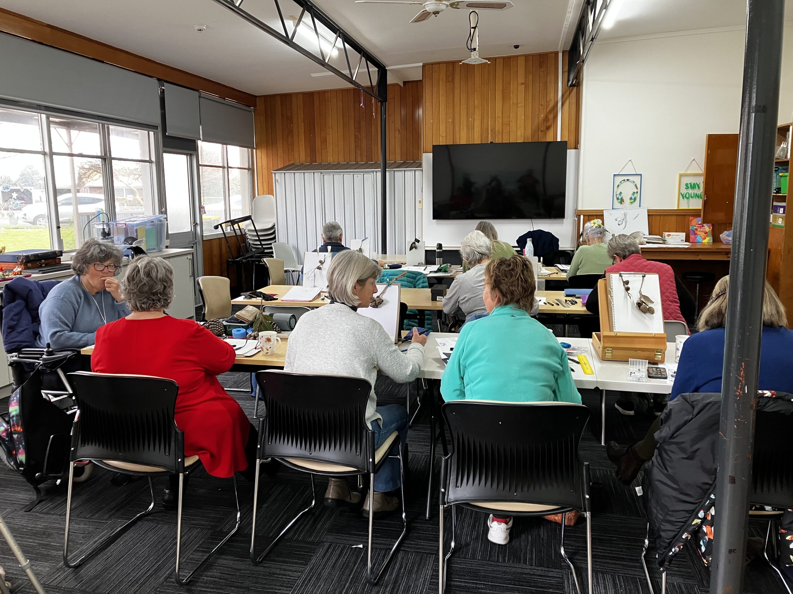 Image of a class room of students learning botanical illustration with Lynda Young Artist Profile with Art Trails Tasmania