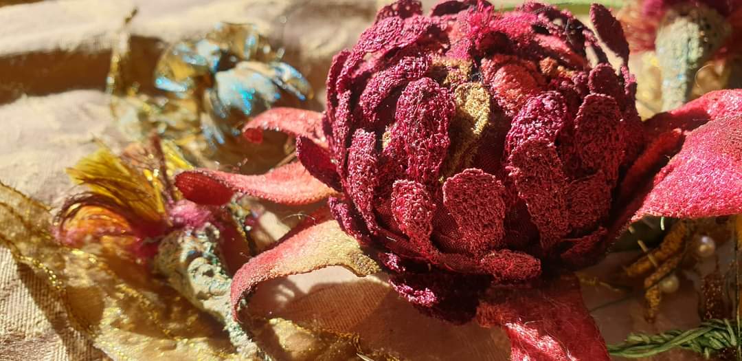 Image shows close up of a textile art Waratah by Cindy Thompson for her Artist Profile with Art Trails Tasmania