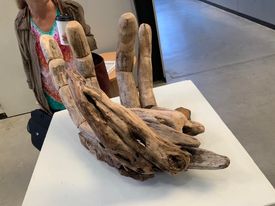 Image of a driftwood sculpture of a Pakana hand by Dean Greeno in his Artist Profile Story with Art Trails Tasmania