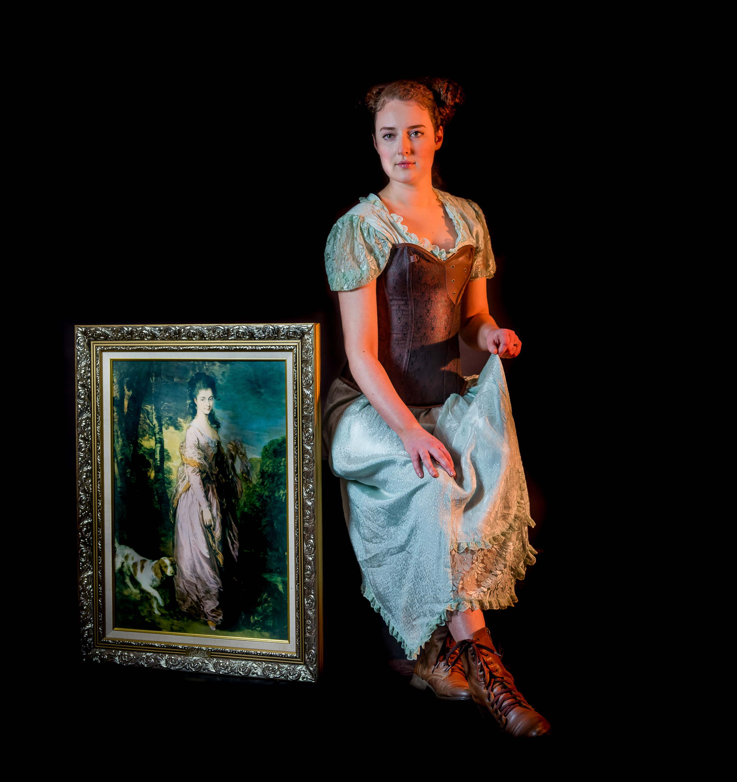 Image shows a photographic portrait of a young woman by a painting of an ancestor for Vince Brophy Artist Profile story with Art Trails Tasmania