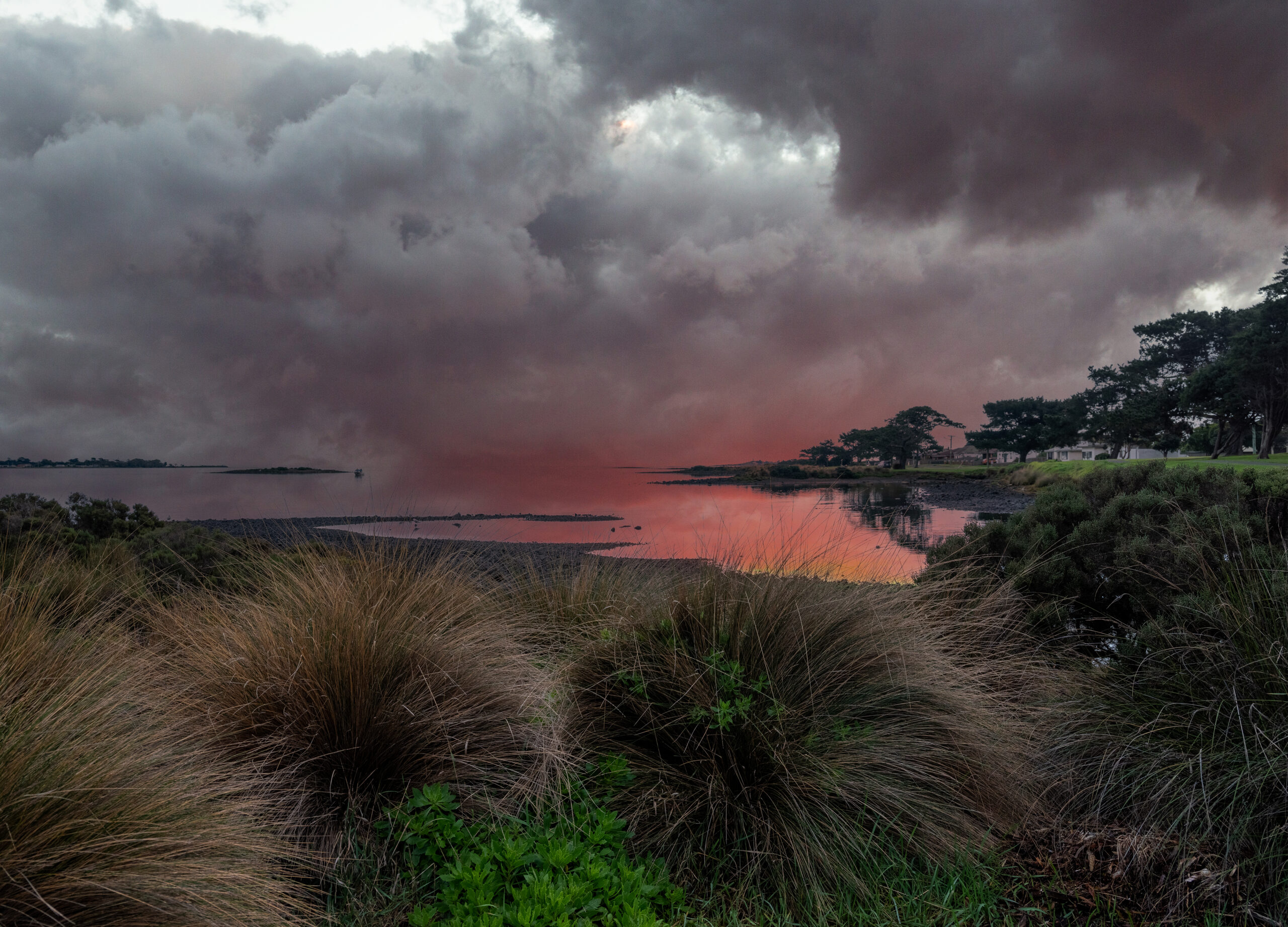Image shows a photo of sunset over water for Vince Brophy Artist Profile story with Art Trails Tasmania