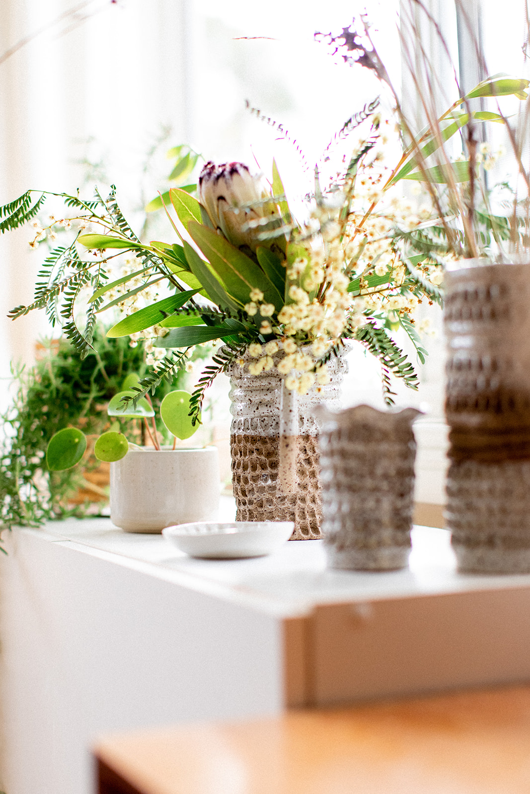 Image shows a protea in a vase by Christie Lange in her Artist Profile Art Trails Tasmania