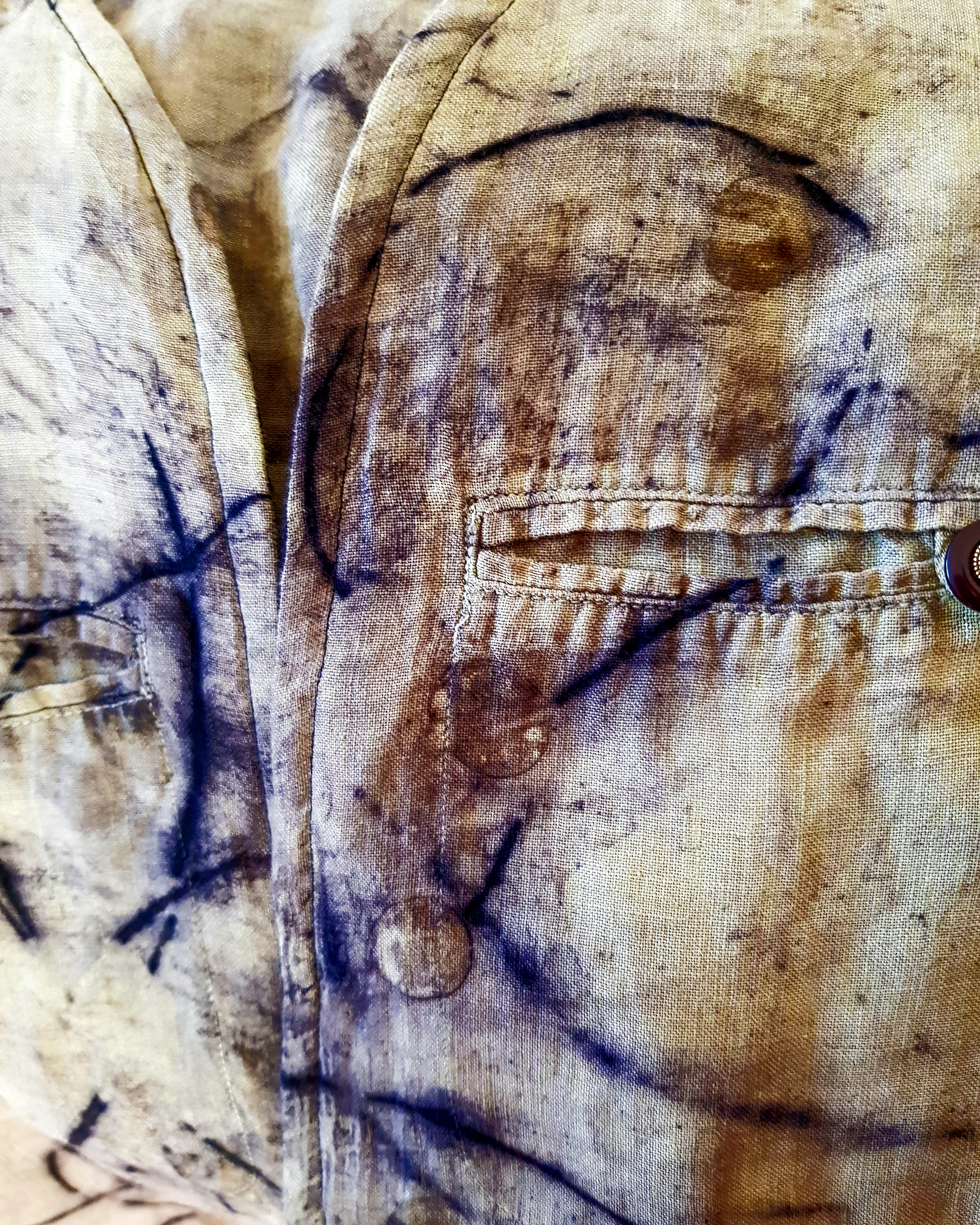 The image shows a close up of eco-dyed fabric for the Textile Art Retreat Found, Collected, Dyed, Stitched with Textile Artist Aujke Boonstra Art Trails Tasmania for her workshop at the Tin Dragon Trails Cottages
