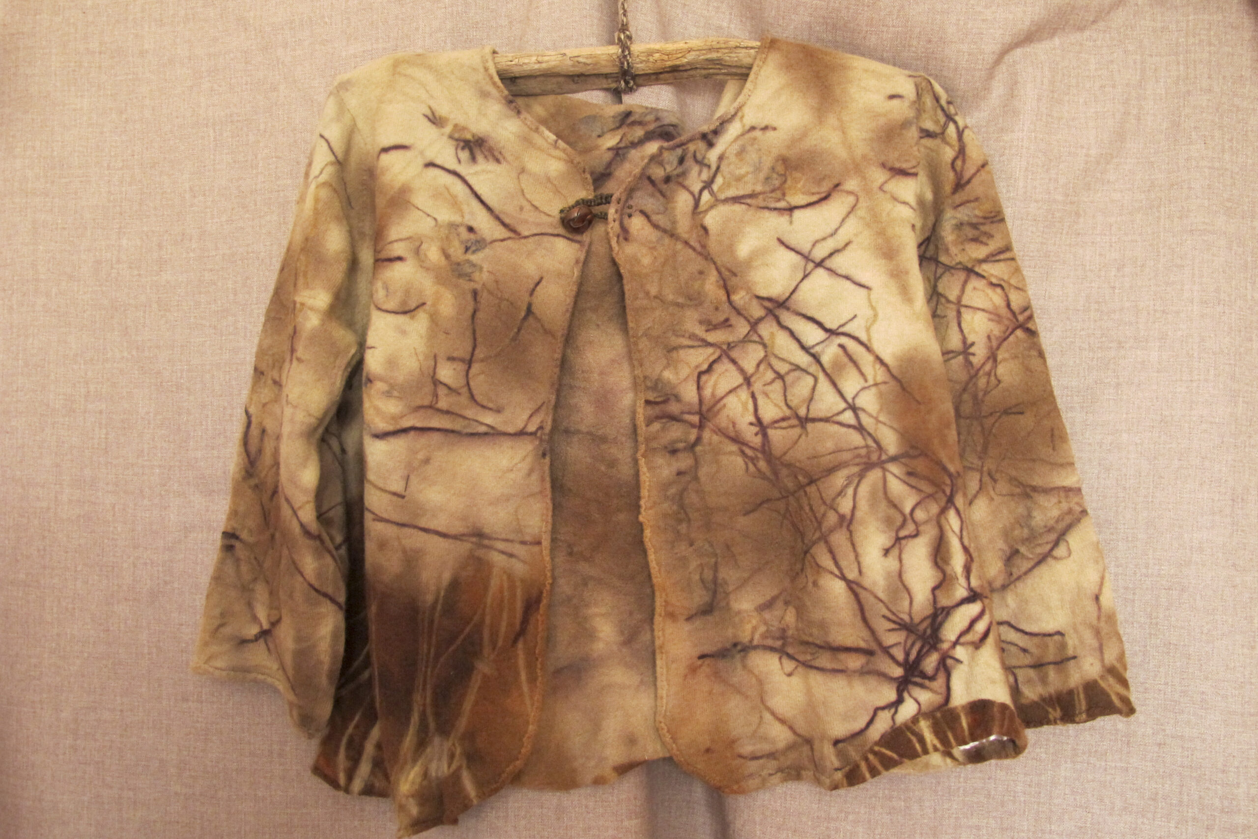 The image shows a jacket made of eco-dyed fabrics for the Textile Art Retreat Found, Collected, Dyed, Stitched with Textile Artist Aujke Boonstra Art Trails Tasmania for her workshop at the Tin Dragon Trails Cottages