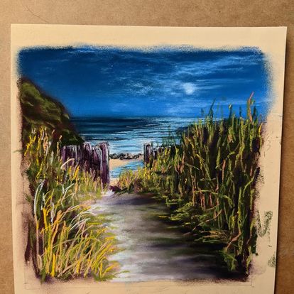 The image shows a pastel rendered image of a path through the sand dunes to a beach at night with a rising moon taped to an art board by Dianne Horvath Art Trails Tasmania