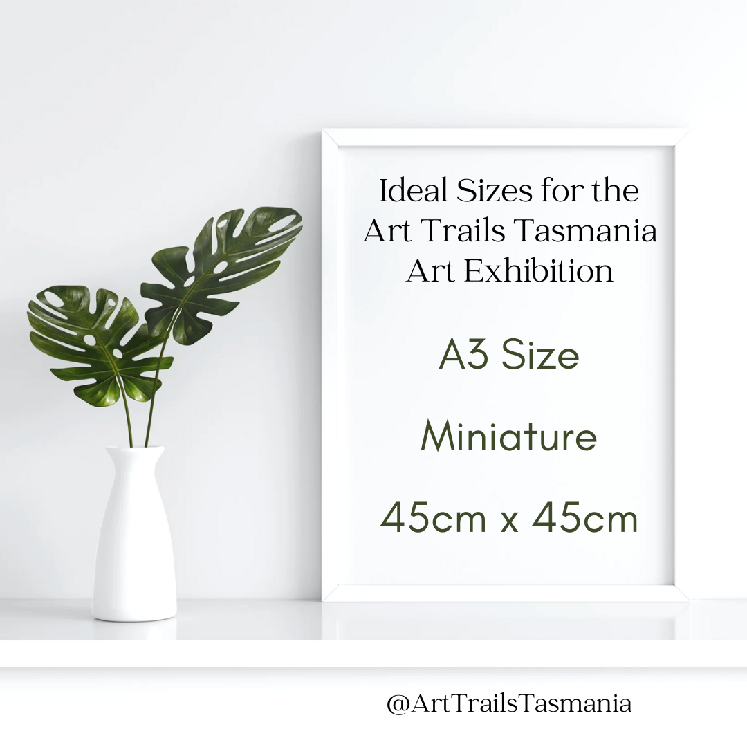 Image shows a minimalist bench with a couple of green leaves in a vase and an A3 frame with the words Thinking sizing for the exhibition, consider A3, Miniatures or the maximum 45x45cm Art Trails Tasmania