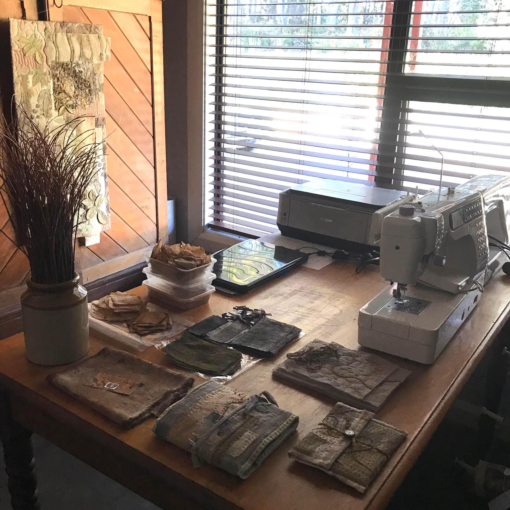 Image shows art studio space with eco dyed fabric slow stitched for the Artist Profile of Renowned Nature Inspired Textile Artist Rita Summers in her Art Trails Tasmania story