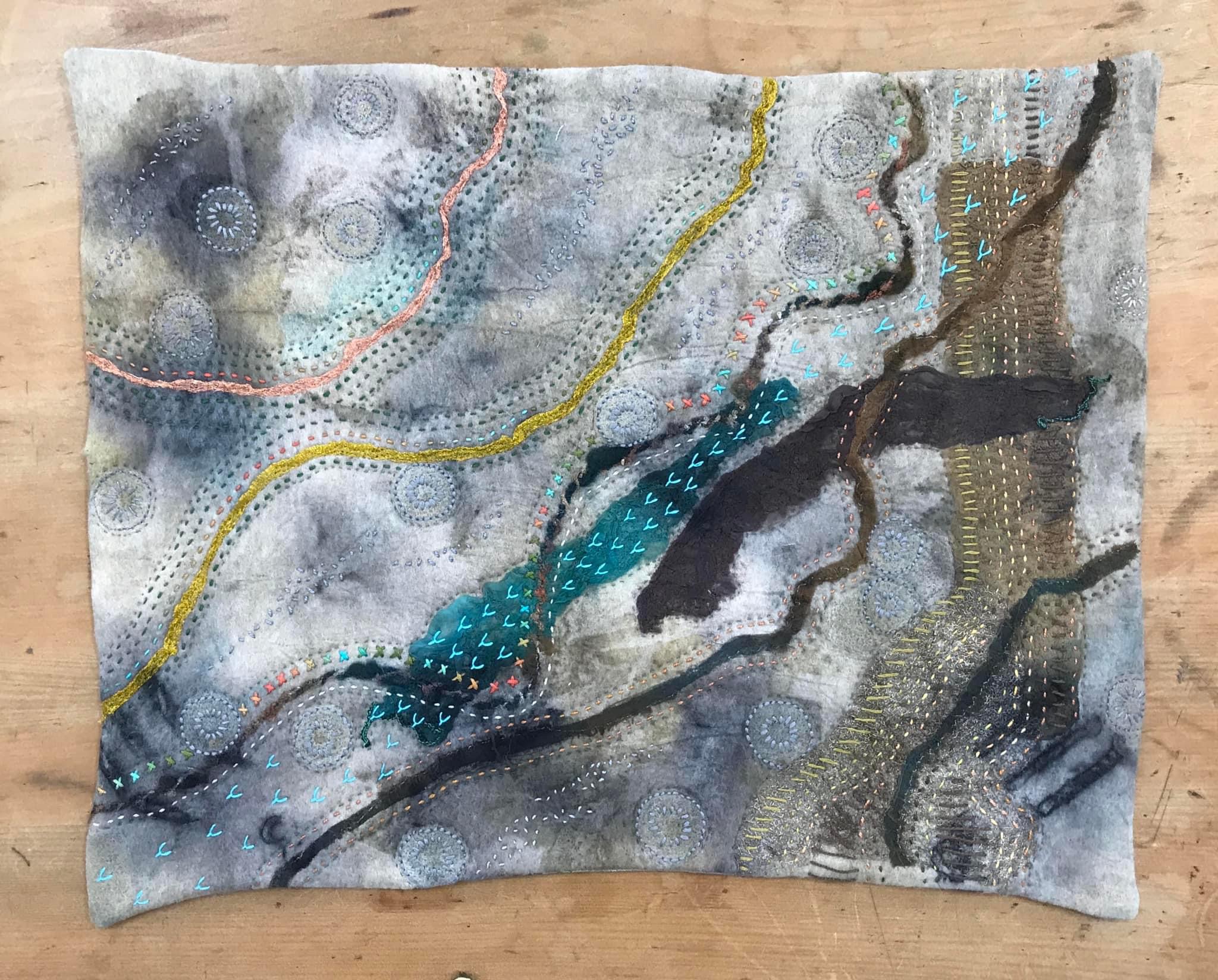 Image shows a piece of eco dyed fabric slow stitched for the Artist Profile of Renowned Nature Inspired Textile Artist Rita Summers in her Art Trails Tasmania story