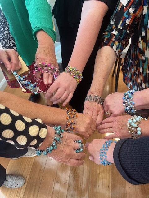 1 Noelene Hammond Workshop Story Art Trails Tasmania Explore Your Creativity Image shows 6 lovely hands with beaded bracelets on the wrists for the Artist Profile An Abiding Love for Colour and Making with Noelene Hammond Art Trails Tasmania Explore Your Creativity