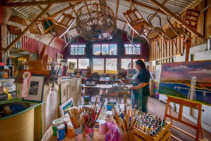 Image shows a verdant landscape with rolling green hills, blue sky with passing clouds for the Artist Profile Sharing Stories and Connections Through Bold Colours and Mark-Making with Julie McDonald Art Trails Tasmania