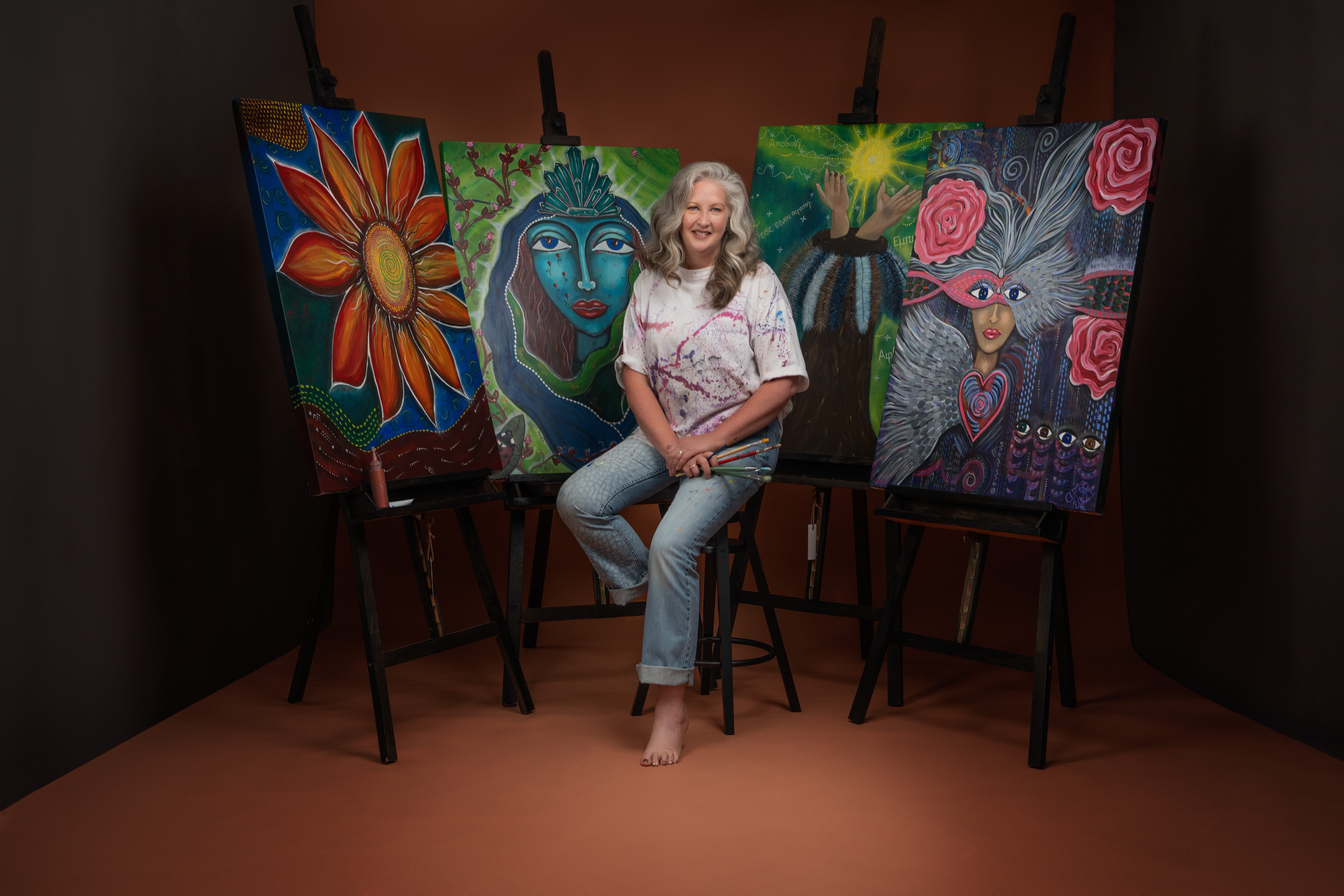 Image shows a verdant landscape with rolling green hills, blue sky with passing clouds for the Artist Profile Sharing Stories and Connections Through Bold Colours and Mark-Making with Julie McDonald Art Trails Tasmania