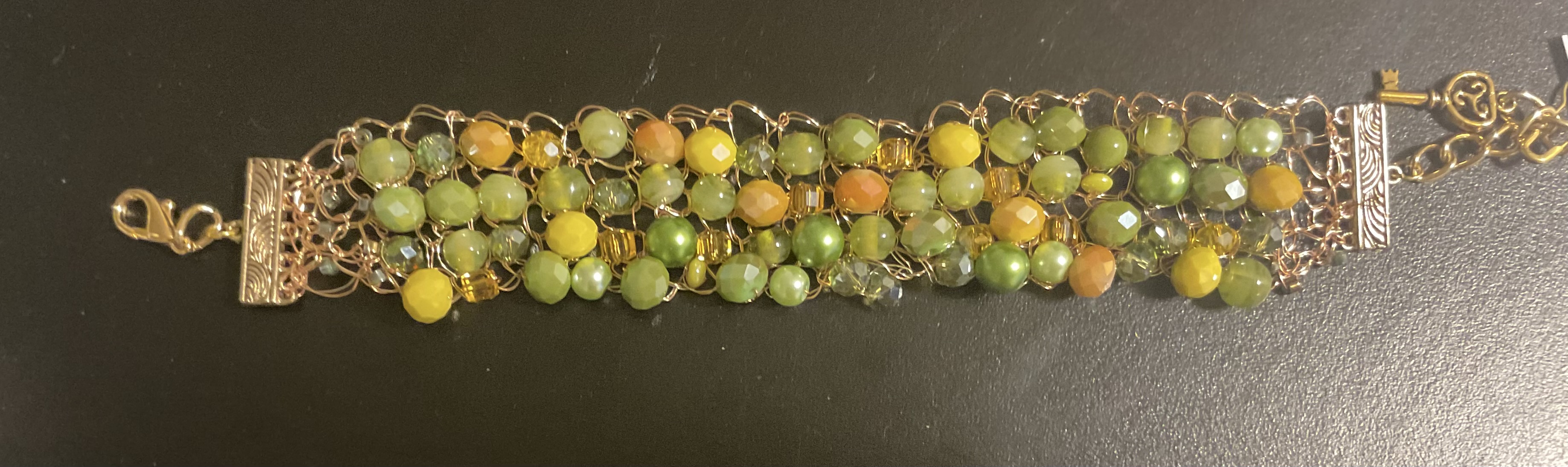 Image shows a beaded necklace in reds and greens for the Artist Profile An Abiding Love for Colour and Making with Noelene Hammond Art Trails Tasmania Explore Your Creativity