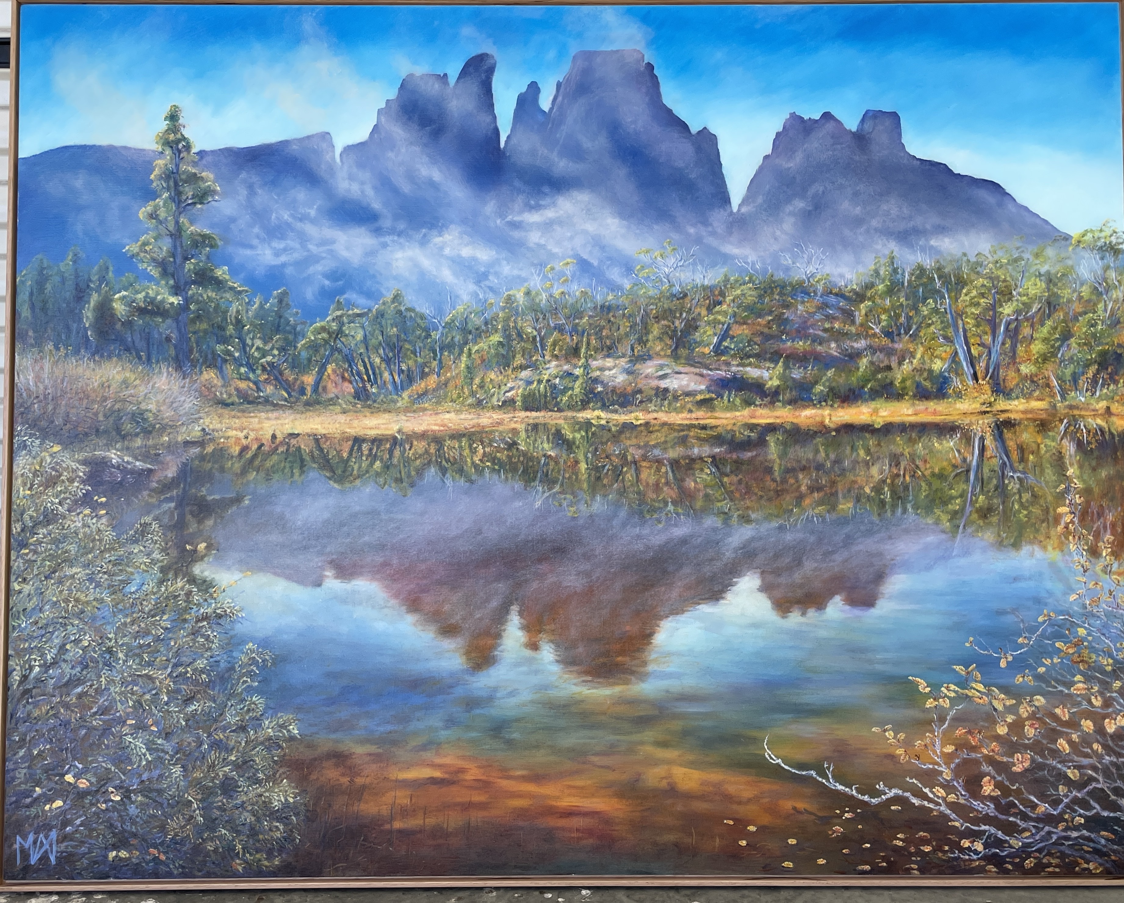 Image shows a verdant landscape with rolling green hills, blue sky with passing clouds for the Artist Profile Sharing Stories and Connections Through Bold Colours and Mark-Making with Julie McDonald Art Trails Tasmania